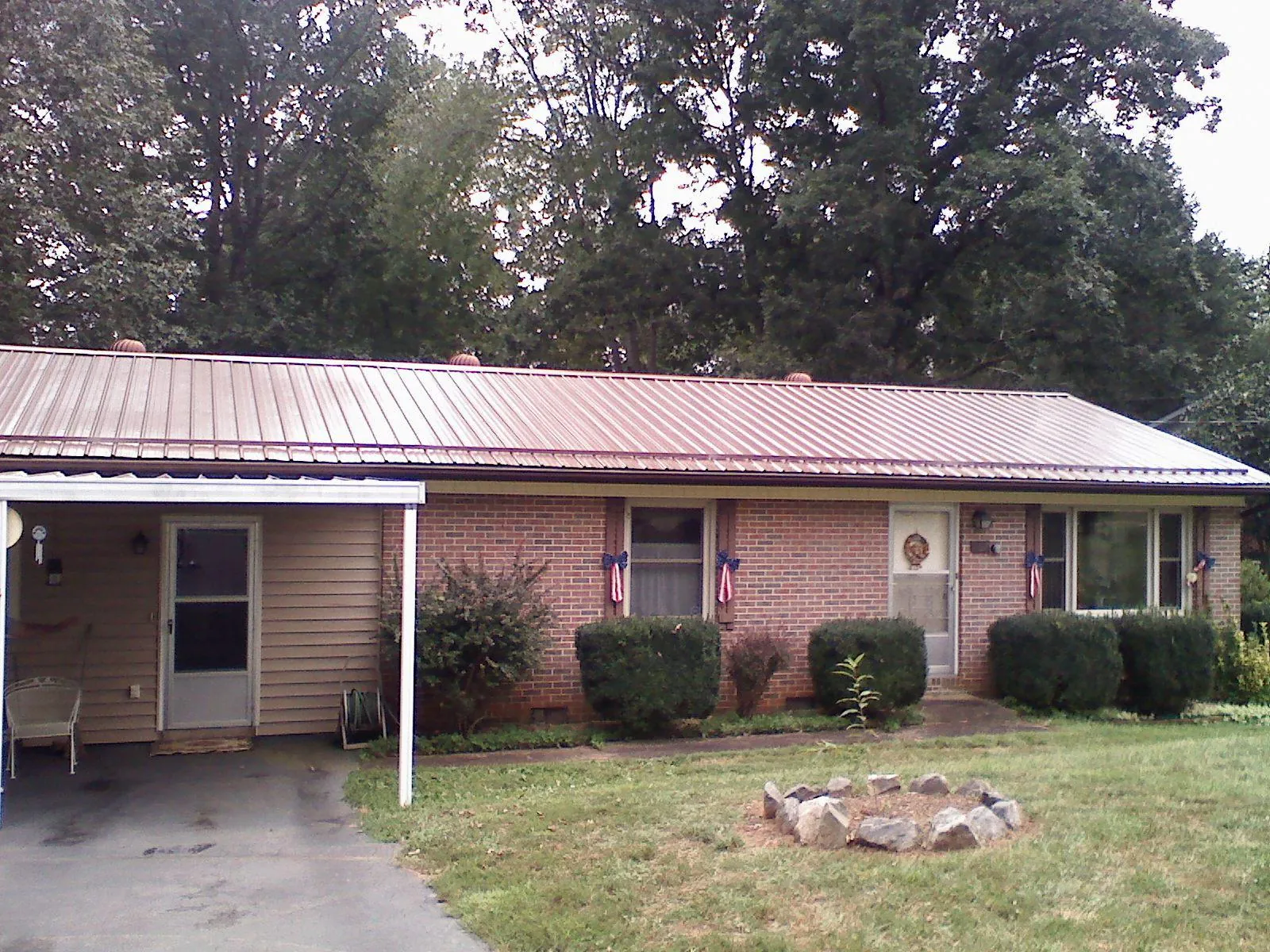 Bronze metal roof and carport on a brick ranch home — Roof Repair work by our crew in Waconia
